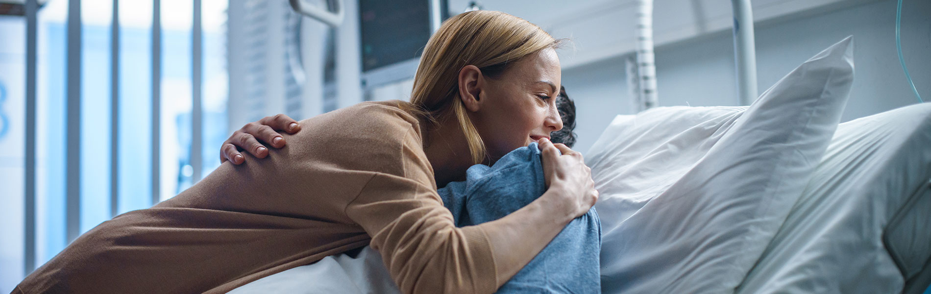 hugs patient in hospital